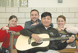 Ethan Velazquez is back enjoying the things he loves—including playing the guitar—thanks to the life-saving efforts of three staff members at Holy Spirit School in Indianapolis: Stacy Inman-Davidson, left, Lucas Stippler and Lauren McLaughlin. (Photo by John Shaughnessy)