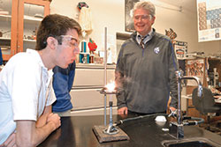 Bishop Chatard High School chemistry teacher Dan McNally smiles at Daniel Burger’s reaction to an experiment. (Submitted photo)