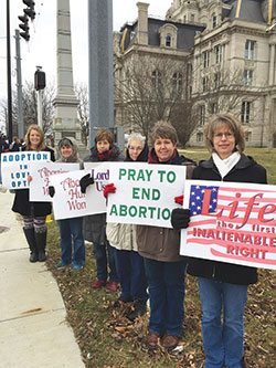Chrysti Stewart, left, Jill Pfister, Ann Welch, Judy March, Doris Fisher and Jennifer Buell hold signs in front of the Vigo County Courthouse in Terre Haute during a pro­life observance on Jan. 27. (Submitted photo by Tom McBroom)