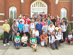 Members of the linked St. Bridget of Ireland Parish in Liberty and St. Gabriel Parish in Connersville pose in front of St. Bridget Church after completing a walking pilgrimage between the churches on Good Friday, April 14. (Submitted photo)