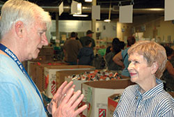 Sheila Gilbert is the first woman to serve as president of the U.S. Society of St. Vincent de Paul. As her six-year term heads into its final months, Gilbert makes a visit to the client-choice food pantry of the Indianapolis Council of the Society of St. Vincent de Paul, where she talks with John Ryan, president of the Indianapolis council. (Photo by John Shaughnessy)