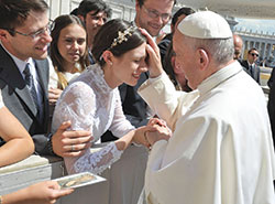 Pope Francis blesses newlywed Katie Rutter and her husband Brian Rutter in St. Peter’s Square at the Vatican on May 3. (Photo courtesy L’Osservatore Romano)
