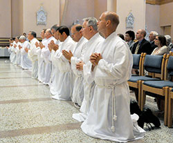 Men being ordained permanent deacons for the Archdiocese of Indianapolis kneel on June 23, 2012, in SS. Peter and Paul Cathedral in Indianapolis. On June 24, 21 men will be ordained permanent deacons in the cathedral as part of the third class of deacons for the Archdiocese of Indianapolis. (File photo by Sean Gallagher)