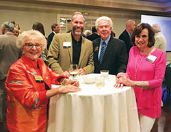 Longtime members of Legatus smile for a photo during social time before the Indianapolis chapter meeting on July 20. Pictured are B.J. Maley, left, John Brand, L.H. Bayley and Dianne Bayley. (Photo by Katie Rutter)