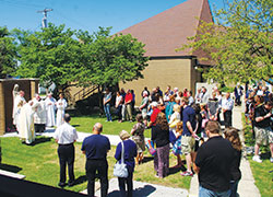 Members of St. Joseph Parish bow their heads in prayer during a blessing of the parish’s Marian grotto as part of the parish’s 150th anniversary celebration on June 25. (Parke County Sentinel photo by Lisa Wood)