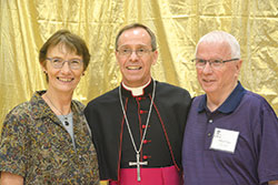 Archbishop Charles C. Thompson smiles with Kathleen and Michael Dryer of St. Christopher Parish in Indianapolis at a reception at the Archbishop Edward T. O’Mara Catholic Center after the Golden Jubilee Anniversary Mass at SS. Peter and Paul Cathedral in Indianapolis on Aug. 27. (Photo by Natalie Hoefer)