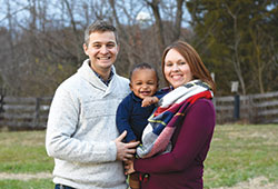 Joe and Jenni Amschler pose with their son Jaxson in January. The Amschlers adopted Jaxson through Adoption Bridges of Kentuckiana, a ministry of St. Elizabeth Catholic Charities in New Albany. (Submitted photo)