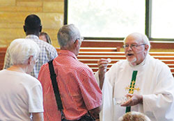 Father Martin Peter distributes Communion during a July 14 Mass at St. Bartholomew Church in Columbus. The retired priest celebrated the 50th anniversary of his priestly ordination earlier this summer. (Photo courtesy of The Republic)