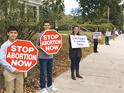 A line of pro-life witnesses extends down a street during a Life Chain rally on Oct. 1 in Bloomington. (Submitted photo by Marian Leahy)