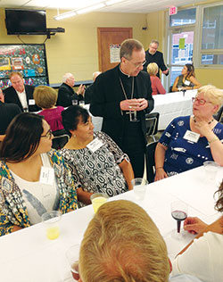Jose Soto, left, Marisa Soto, both members of St. Ambrose Parish in Seymour, and Shirley Boardman, right, a member of St. Agnes Parish in Nashville, talk with Archbishop Charles C. Thompson during a Miter Society dinner on Sept. 26 at Holy Family Parish in New Albany. (Photo by Leslie Lynch)