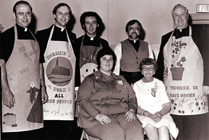 This photograph was taken at an event honoring senior citizens at St. Gabriel Parish in Connersville in May 1981. Following Mass said by Archbishop Edward T. O’Meara, several priests served dinner to 300 seniors in attendance. The priests are, from left to right, Fathers Harold Knueven, Stephen Jarrell, Glenn O’Connor, Robert Mazzola, and Archbishop O’Meara. Seated in front of the priests are Mistress of Ceremonies Karolyn Buckler and Elizabeth Mazzola, the mother of Father Mazzola, who made the archbishop’s apron. This photo originally appeared in the Connersville News Examiner.