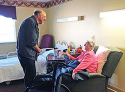 Deacon Ronald Freyer, left, listens to Franciscan Sister Francis Clements during a visit to St. Andrews Health Campus in Batesville on Oct. 22. Visiting the sick in hospitals and nursing homes in the southeastern Indiana town is part of Deacon Freyer’s ministry. (Submitted photo by Katie Rutter)