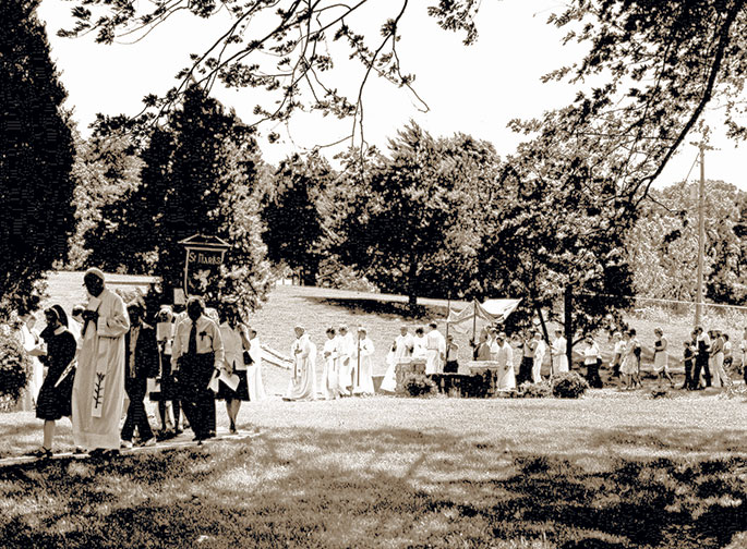 This photograph was taken at an event honoring senior citizens at St. Gabriel Parish in Connersville in May 1981. Following Mass said by Archbishop Edward T. O’Meara, several priests served dinner to 300 seniors in attendance. The priests are, from left to right, Fathers Harold Knueven, Stephen Jarrell, Glenn O’Connor, Robert Mazzola, and Archbishop O’Meara. Seated in front of the priests are Mistress of Ceremonies Karolyn Buckler and Elizabeth Mazzola, the mother of Father Mazzola, who made the archbishop’s apron. This photo originally appeared in the Connersville News Examiner.