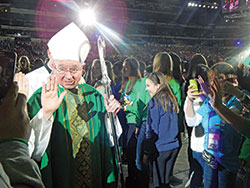 Archbishop Jose H. Gomez waves as he processes out of the closing Mass of the National Catholic Youth Conference on Nov. 18. (Photo by Mike Krokos)