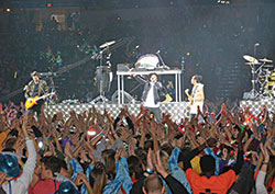 The young crowd delights in the music of Christian hip-hop band TobyMac on the opening night of the National Catholic Youth Conference on Nov. 16. (Photo by Natalie Hoefer)