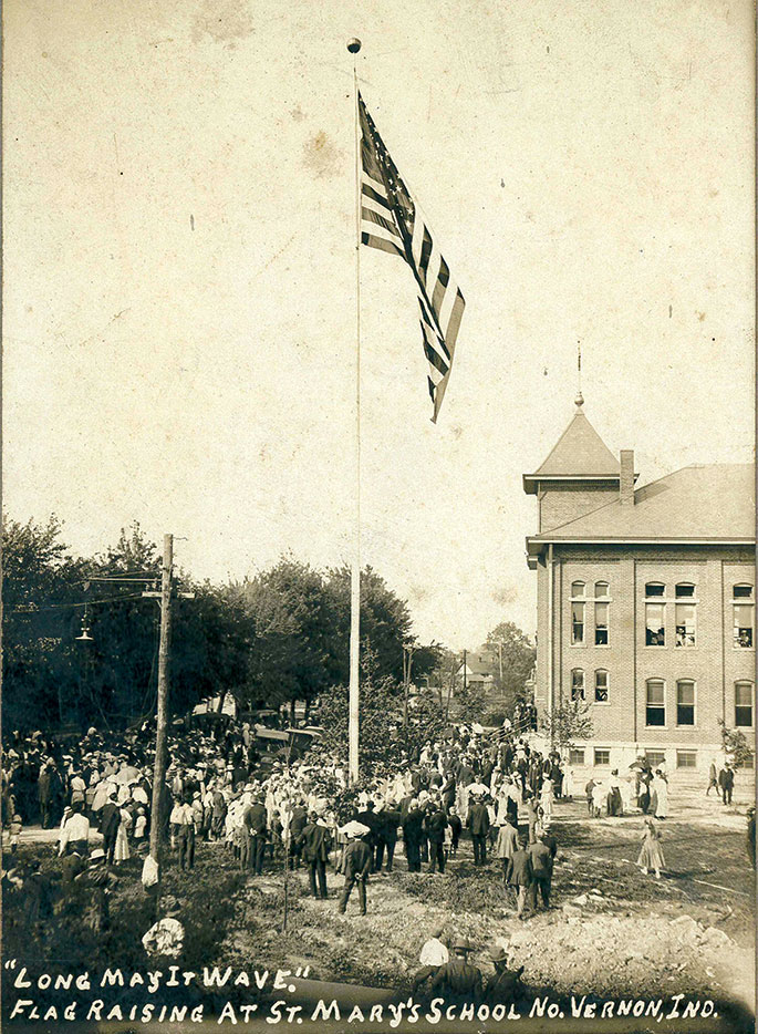This photo shows a flag raising event at St. Mary School in North Vernon. Though no date is given on the photo, it could depict celebrations related to the dedication of the school building by Bishop Denis O’Donoghue, former auxiliary bishop of Indianapolis, on June 21, 1908. St. Mary Parish was founded in 1861, and the school continues to operate in the building shown in this photograph.