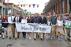 Students from Saint Theodore Guérin High School in Noblesville, Ind., in the Lafayette Diocese, lead a procession of approximately 500 participants along Capitol Avenue in Indianapolis on Jan. 22 for the inaugural Indiana March for Life, an event coordinated by the Archdiocese of Indianapolis, the Lafayette Diocese and Right to Life of Indianapolis. (Photo by Natalie Hoefer)