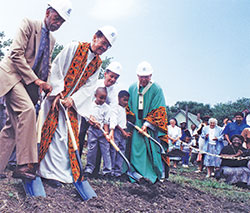 Archbishop Daniel M. Buechlein, right, breaks ground on Aug. 9, 1998, on the grounds of Holy Angels Parish in Indianapolis for a new school building for the faith community. It was the first new center-city Catholic school in the U.S. constructed in 40 years. Breaking ground with Archbishop Buechlein are Holy Angels parishioner Ted Gary, left, Father Clarence Waldon, pastor, Indianapolis Mayor Stephen Goldsmith, and Holy Angels third graders Evan Carpenter and Jonathan Butler. (File photo by Margaret Nelson)