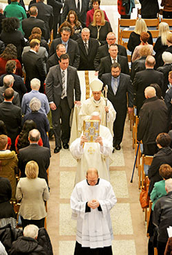 Indianapolis Archbishop Charles C. Thompson processes in front of the casket of Archbishop Emeritus Daniel M. Buechlein, former shepherd of the Church in central and southern Indiana, at the end of his Jan. 31 funeral Mass at SS. Peter and Paul Cathedral in Indianapolis. Archbishop Buechlein died on Jan. 25 at age 79. (Photo by Natalie Hoefer)