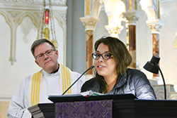 Father Michael O’Mara, pastor of St. Gabriel the Archangel Parish in Indianapolis, listens as Zahrya Aremas of St. Patrick Parish in Indianapolis shares her witness as a Dreamer—an undocumented immigrant brought to the United States as a child—after a special Mass for “Catholic Day of Action for Dreamers” on Feb. 27 at St. John the Evangelist Church in Indianapolis. (Photo by Natalie Hoefer)