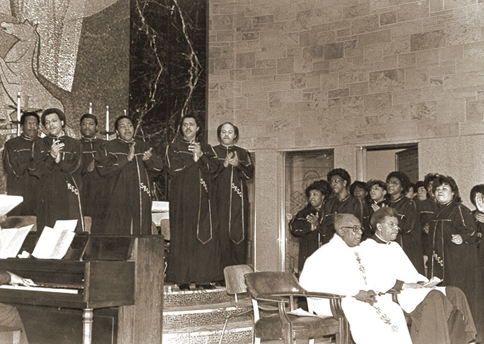 In this photo originally published in The Criterion on May 13, 1983, the Emmaus Choir of St. Rita Parish in Indianapolis performs Gospel music during a liturgy. Seated, from left to right, are Divine Word Father Elmer Powell, who was pastor of St. Rita from 1980-1983, and Maurice Guynn, an extraordinary minister of holy communion and lifelong member of the Indianapolis East Deanery faith community.
