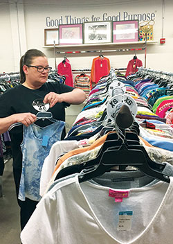 Connie Wright, a graduate of the Indianapolis St. Vincent de Paul Society’s Changing Lives Forever program, restocks clothes on March 17 as part of her job at the charitable organization’s Mission 27 Resale shop in Indianapolis. Funds raised by the store benefit the Changing Lives Forever program—which helps individuals learn how to pull themselves out of poverty—as well as the St. Vincent de Paul Food Pantry. (Photo by Natalie Hoefer)
