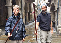 In a moment of celebration, Luke Hutchins, left, and Mark Peredo raise the walking sticks they purchased in Santiago de Compostela in northwestern Spain—walking sticks that serve as mementos of their memorable journey across the Camino. (Submitted photo)