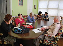 A Court Appointed Special Advocate (CASA) volunteer meeting takes place on April 3 in New Albany. Pictured are left, Debbie Mefford, director of St. Elizabeth Catholic Charities’ CASA program; volunteer Cheryl Schy; Kerma Hopewell, staff advocate/recruiter; and volunteers Donna Sherrard, Lynda Grunzinger and Paul Grunzinger. (Submitted photo)