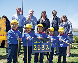 Members of the Central Catholic School preschool class wear hard hats and hold shovels and are accompanied during an April 20 groundbreaking ceremony in Indianapolis by, back row, from left: Dan O’Melveny and Eric Haake representing Shea Family Charities; Gina Kuntz Fleming, superintendent of the Archdiocese of Indianapolis; Aaron Brenner, Notre Dame Alliance for Catholic Education; and Ruth Hurrle, Central Catholic School principal. (Submitted photo)