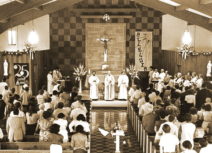 On Aug. 22, 1982, St. Monica Parish in Indianapolis celebrated the 25th anniversary of its founding with a Homecoming Mass. Father Kenneth Taylor, associate pastor of St. Monica at the time, is at left before the altar. In the center is Father Albert Ajamie, then St. Monica’s pastor. The Mass was followed by a dinner in the parish hall. St. Monica Parish was founded in 1957. The first Mass in the parish was celebrated on Aug. 11 of that year.