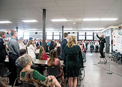 In the St. Louis School cafeteria in Batesville, Archbishop Charles C. Thompson stands on a chair to help the youths of five Batesville Deanery parishes practice their responses prior to the Mass in which they received the sacrament of reconciliation on April 21. (Waltz Photography, LLC)