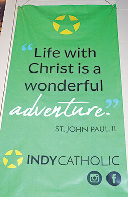 A banner captures one of the defining themes of the archdiocese’s Office of Young Adult and College Campus Ministry. The website for the archdiocesan ministry for young adults is www.IndyCatholic.org. (Photo by John Shaughnessy)