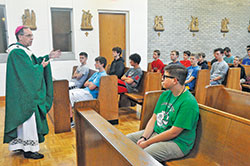 Teenage boys from across central and southern Indiana listen on June 27 to Archbishop Charles C. Thompson deliver a homily during a Mass that was part of the 13th annual Bishop Bruté Days at Bishop Simon Bruté College Seminary in Indianapolis. Sponsored by the archdiocesan Vocations Office, Bishop Bruté Days is a vocations camp for teenage boys open to the priesthood. (Photo by Sean Gallagher)