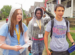 High schoolers Sarah Hagen, left, of St. Louis de Montfort Parish in Fishers, Ind., in the Diocese of Lafayette; Joan Njoroge of Holy Angels Parish in Indianapolis; and Aidan Galt of St. Barnabas Parish in Indianapolis navigate through an underserved neighborhood on the south side of Indianapolis searching for edible plants on June 21. The unique scavenger hunt aimed to help the students better understand poverty, and was part of the Missionary Disciples Institute hosted by Marian University in Indianapolis. (Photo by Katie Rutter)