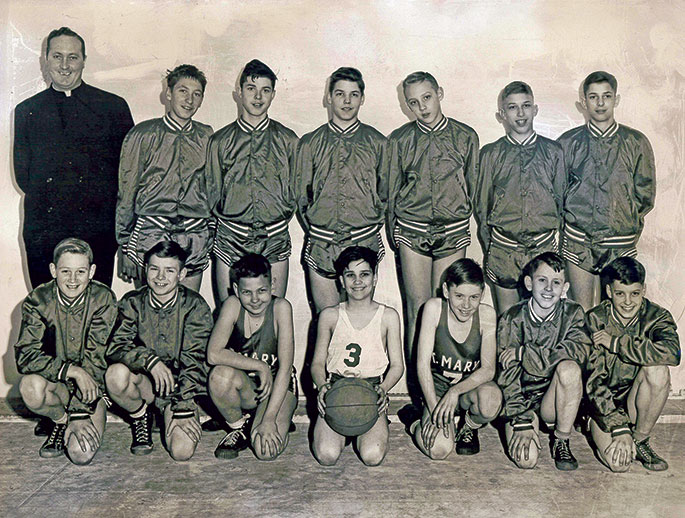 In this photo from 1948, the boys’ cadet basketball team from St. Mary Parish in New Albany celebrated their CYO tournament victory over the team from St. Peter Parish in Franklin County. The final score of the game was 25-17. The team is pictured with their coach, Father Donald Coakley, who was the associate pastor of St. Mary Parish from 1946-1950.