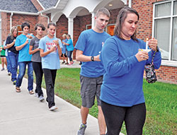 Members of St. Maurice Parish in Napoleon participate on Sept. 22 in a candlelight procession to their faith community’s church during a celebration of a year in which parish events were tied together by the theme “Set Your Faith on Fire.” The parishioners are, front, from right, Tara Ricke, Kevin Simon, Cloey Simon, Kayla Simon, Jenny Rickey and Dottie Hellmich. (Photo by Sean Gallagher)