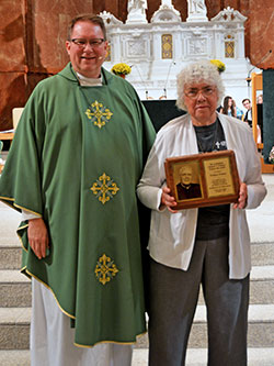 Patricia Vesper, a member of St. Luke the Evangelist Parish in Indianapolis, stands next to Father Joseph Feltz after receiving the 2018 Archbishop O’Meara Respect Life Award at the archdiocesan Respect Life Mass at SS. Peter and Paul Cathedral on Oct. 7. Father Feltz presided at the archdiocesan Respect Life Mass. (Photo by Natalie Hoefer)
