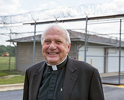 Father David Link has dedicated his life to prison ministry for nearly 20 years. He will be the keynote speaker at a corrections ministry conference in the Archdiocese of Indianapolis on Nov. 3. Here he is pictured outside the South Bend Community Re-Entry Center in South Bend, Ind. (Photo courtesy of Santiago Flores, South Bend Tribune.)