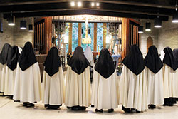 Members of the Discalced Carmelite Monastery of St. Joseph in Terre Haute stand during a celebration of the Mass. Prayer for the Church and the world, both communal and individual, is the primary vocation of the cloistered Carmelite community. (Submitted photo)