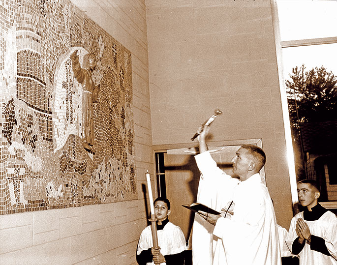 In this photo from Oct. 9, 1960, Father George Powers blesses a statue and mosaic of St. Leonard at the former St. Leonard of Port Maurice Church in West Terre Haute. The statue was blessed as part of a Forty Hours Devotion held at the parish beginning that day. St. Leonard of Port Maurice was a Franciscan who lived in Italy during the eighteenth century and fostered great devotion to the Stations of the Cross. The Terre Haute Deanery faith community was closed in 2011. 