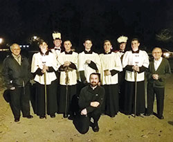 Father Dustin Boehm, pastor of St. Gabriel Parish in Connersville and St. Bridget of Ireland Parish in Liberty, poses with altar servers, members of the parish’s Knights of Columbus and others prior to one of St. Gabriel’s “Novena of Sundays” rosary walk evenings. (Submitted photo)