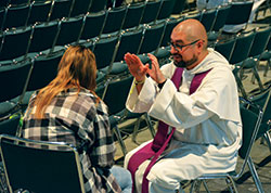 A priest offers absolution to a SEEK2019 participant after hearing their confession on Jan. 5. (Photo by Natalie Hoefer)