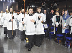 Archdiocesan seminarians James “JJ” Huber and Andrew Alig, front left and right, lead the procession for the opening Mass of SEEK2019 on Jan. 3 at the Indiana Convention Center in Indianapolis. (Photo by Sean Gallagher)