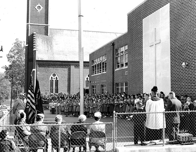 This photo from 1960 depicts scouting groups, as well as representatives of the Keith Ross Post #231 of the American Legion, participating in a flag ceremony at St. Mary Parish in Aurora. If you know what occasion was being commemorated during this ceremony, please contact the archives.