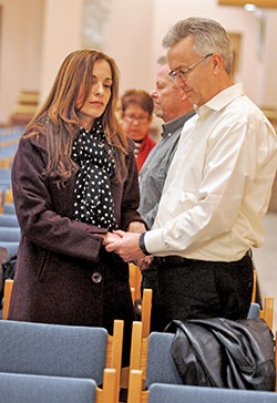Dora and Bruce Feldman, members of St. Jude Parish in Indianapolis, hold hands while renewing their marriage vows on Feb. 10 during a World Marriage Day Mass at SS. Peter and Paul Cathedral in Indianapolis. (Photo by Sean Gallagher)