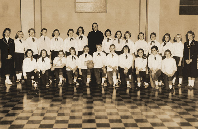 The members of the Immaculate Heart of Mary Parish kickball team in Indianapolis were the champions of the spring CYO kickball season in 1957. They defeated the team from St. Therese of the Infant Jesus (Little Flower) Parish, also in Indianapolis. The priest appearing in the center of the second row is Father James Hodge, who was associate pastor of Immaculate Heart from 1956-1958.