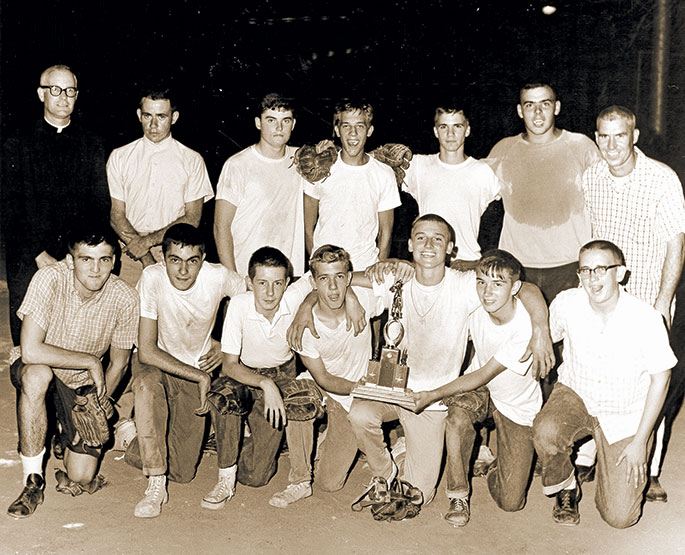In 1963, the junior boys’ softball team from St. Anthony Parish in Indianapolis defeated the team from St. Philip Neri Parish, also in Indianapolis, by a score of 18-7 to win the CYO championship. The championship came at the end of an undefeated season for the team. In the back row on the far left is Father James Byrne, the priest moderator for the team. In the back row on the far right side is Joe Fox, the head coach. This photo was originally published in the Sept. 6, 1963, issue of The Criterion.