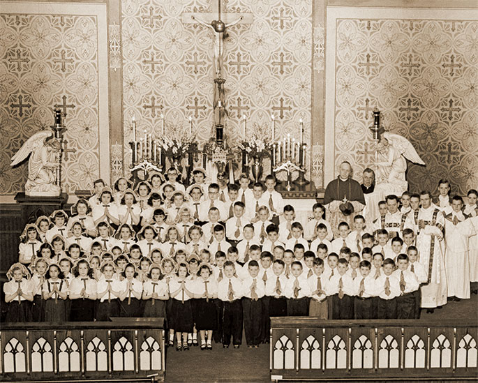 In this photo from March 1, 1953, children of St. Patrick Parish in Terre Haute receive the sacrament of confirmation. Archbishop Paul C. Schulte can be seen in the back row, second from the right. On the far right in the back row is Father Herbert Winterhalter, who was pastor of the parish from 1950-1967.
