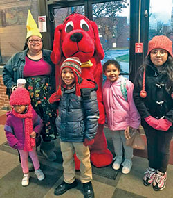 Showing her ‘young at heart’ spirit, Sarah Jean Watson, principal of St. Lawrence School in Indianapolis, gets in on the fun with some of her students for a photo opportunity with Clifford the Big Red Dog. (Submitted photo)