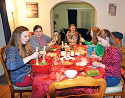Perry Langley, left, Corinne DeLucenay, Anna Schmalzried, Brea Cannon and Julia Payne share a meal at FIAT Formation House for Women on Jan. 28 in Indianapolis. (Photo by Natalie Hoefer)